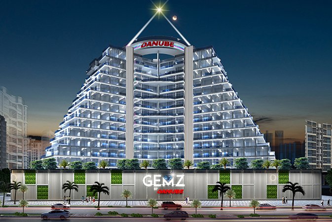 GEMZ by Danube luxury residential tower with illuminated balconies, pyramid-style architecture and landscaped frontage