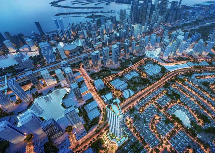 Aerial night view of Dubai waterfront city with illuminated skyscrapers, roads, villas and modern urban planning scene