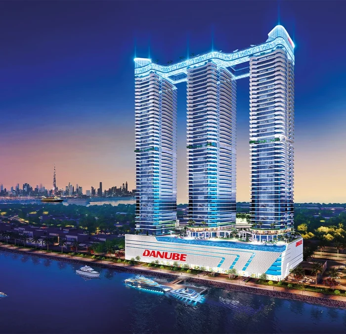 GEMZ by Danube luxury residential tower with illuminated balconies, pyramid-style architecture and landscaped frontage