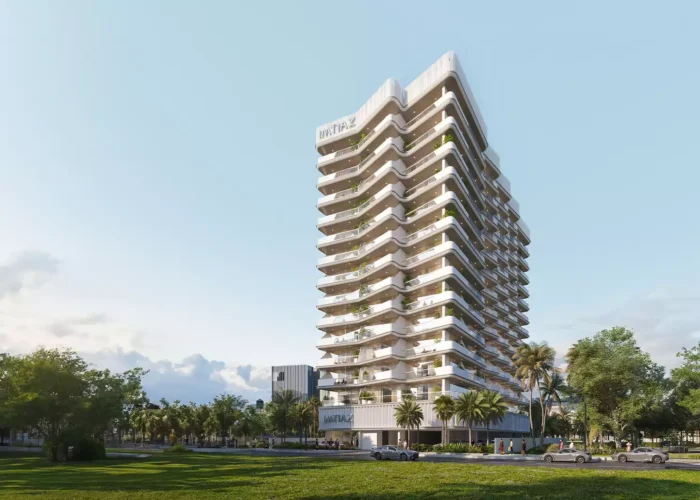 Modern luxury residential tower with layered balconies, landscaped lawns, palm trees and contemporary urban living environment