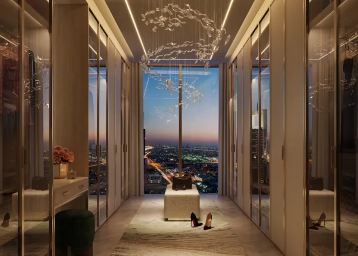 Luxury walk-in wardrobe with elegant lighting, glass wardrobes, modern decor and panoramic city skyline view at night