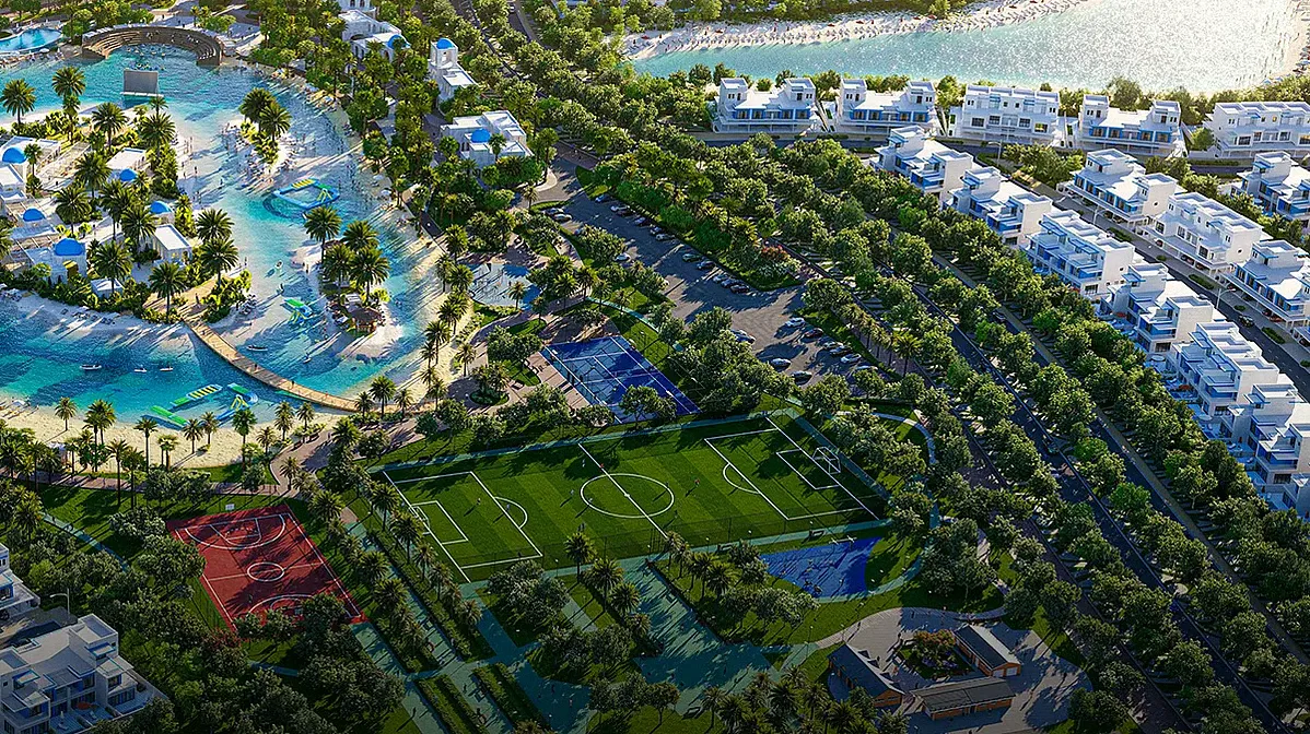Luxury community with lagoon, sports courts, football field, landscaped greenery and waterfront villas views Dubai lifestyle