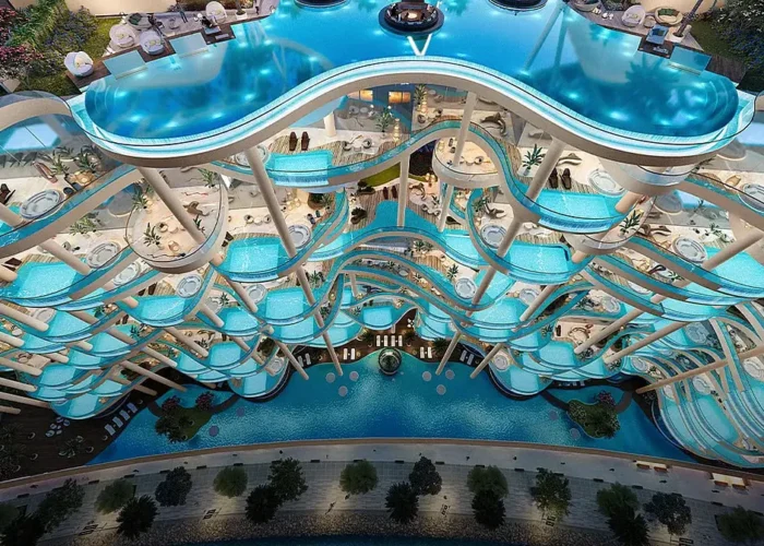 Luxury multi level infinity pool design with flowing curves, illuminated water features and premium resort style amenities