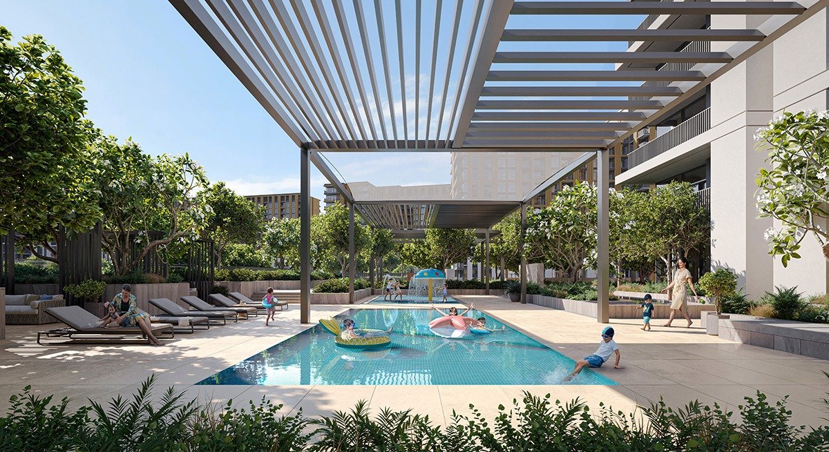 Family swimming pool in modern residential community with shaded pergola, kids play area, loungers and lush greenery