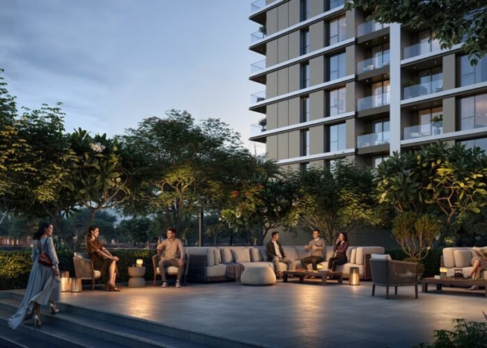 Residents relaxing in luxury outdoor lounge with modern seating, ambient lighting, landscaped gardens and apartment view