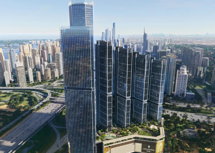 Aerial view of luxury high-rise towers in Dubai with modern glass facades, landscaped podium, highways and city skyline views