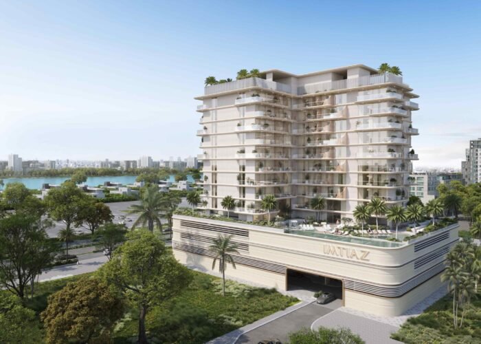 Luxury residential building with modern balconies, landscaped podium, palm trees and serene waterfront city surroundings